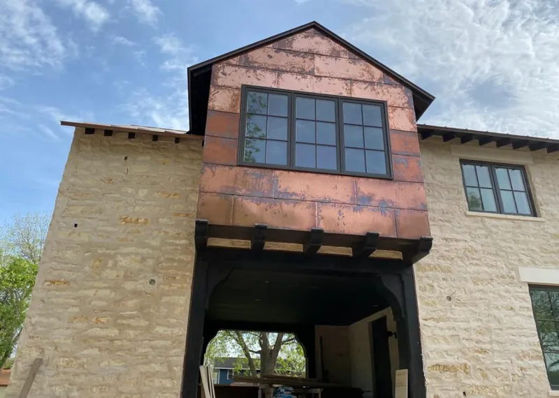 Copper metal panel facade on a stone building for Roof Repair in West Caldwell