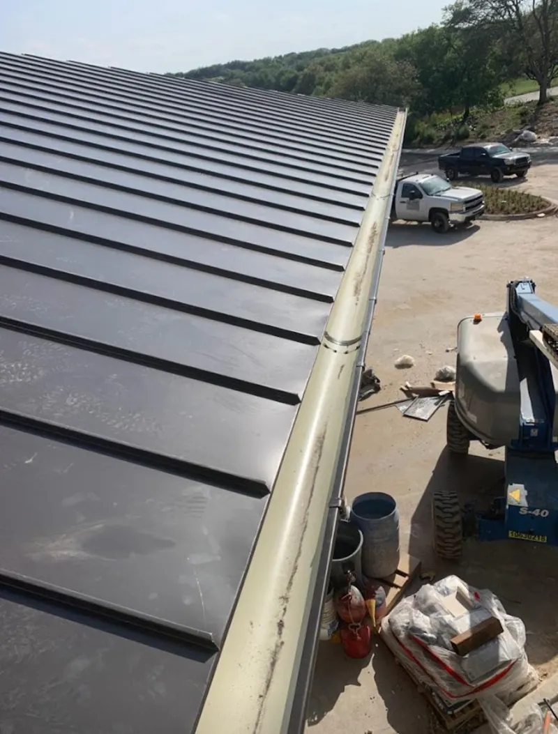 Standing seam panel and gutter detail on a metal roofing jobsite in West Caldwell